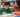 Child reading with a supportive adult and a line guide.