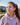Child wearing purple therapeutic glasses outdoors